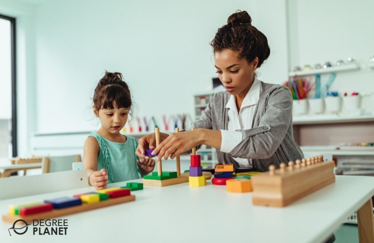 preschool teacher assisting a child in a daycare