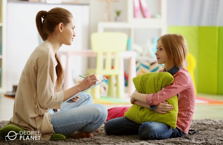 child therapist talking to a young patient