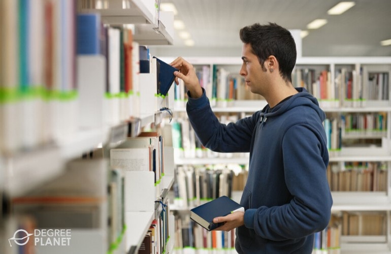 college student looking for a book in the library