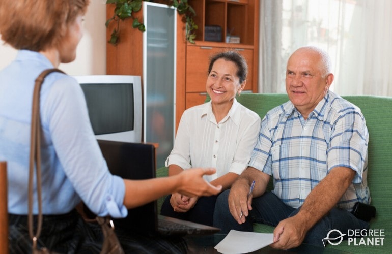 Social Service worker visiting the home of an elderly couple