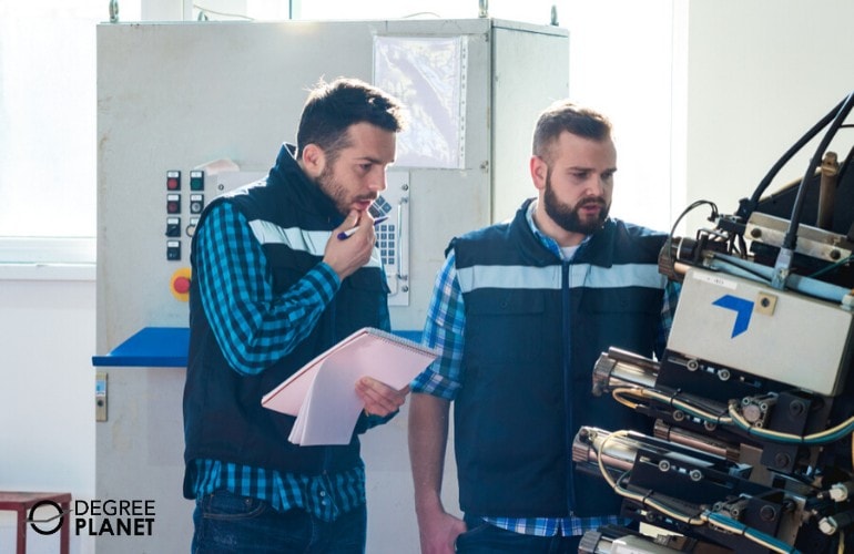 Industrial Engineering Technicians monitoring equipment in a factory