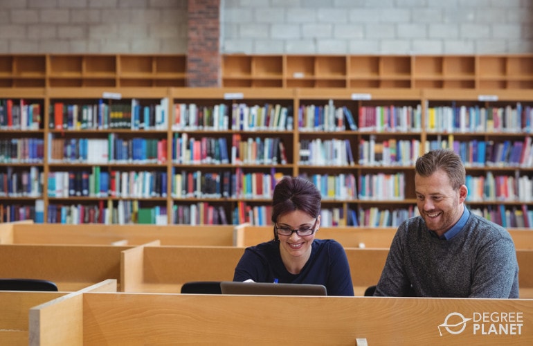 PhD students studying together in library