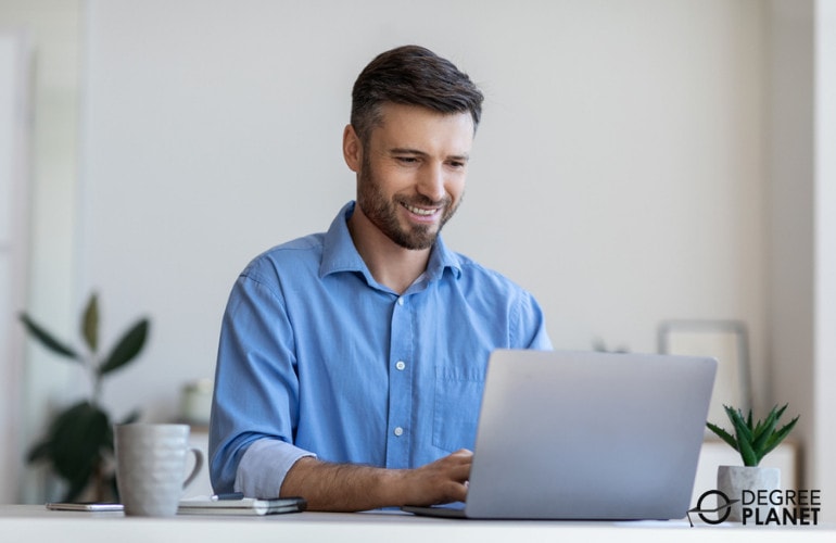 Human Resources Specialist working in front of his laptop