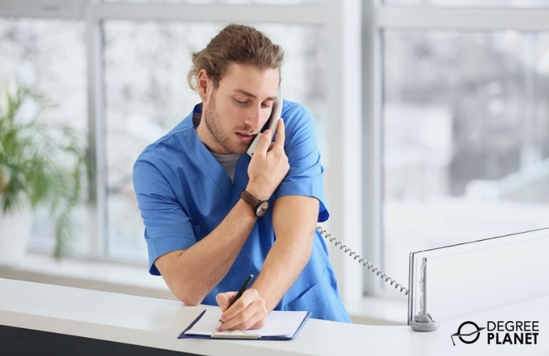 Medical Assistant taking notes while on a phone call