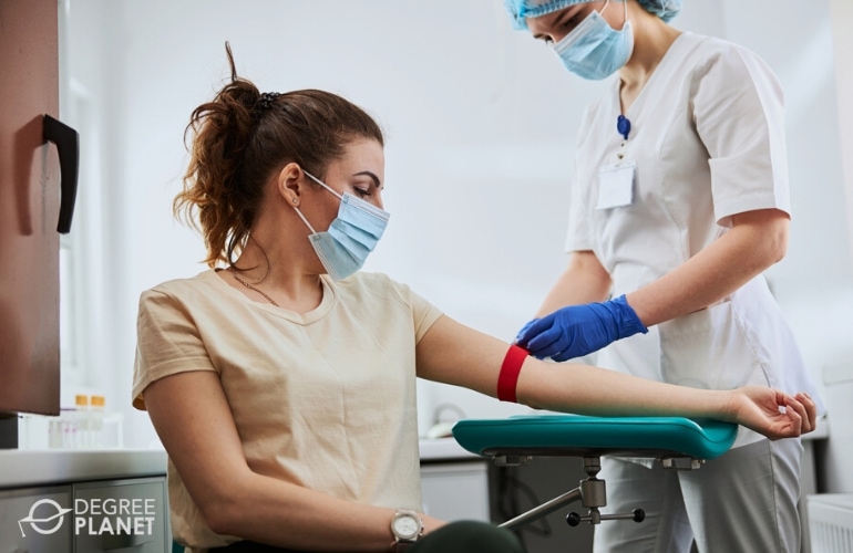 phlebotomist taking patient's blood
