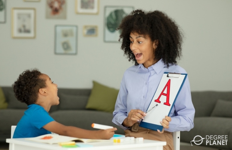 Speech-Language Pathologist guiding a child