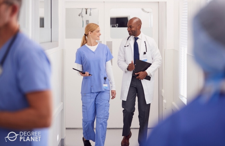 Nurse Practitioner and doctor talking in the hospital hallway