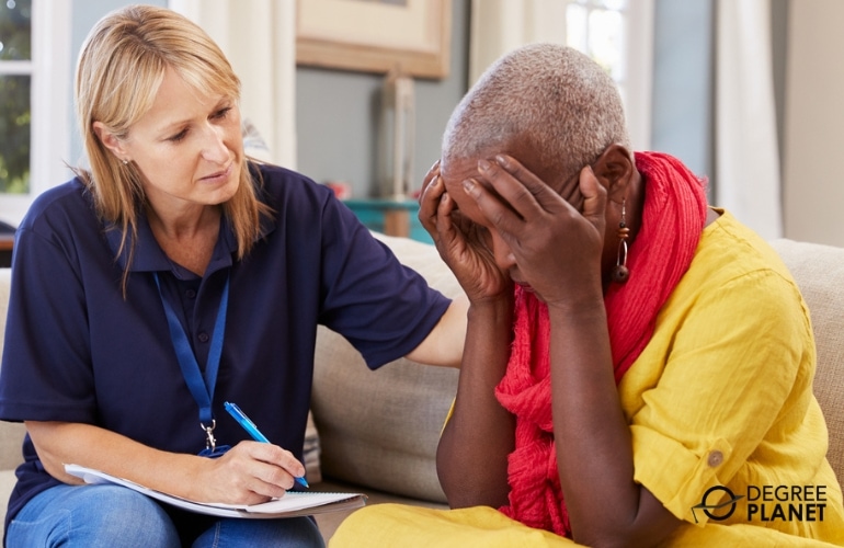 Social Worker comforting an emotional elderly