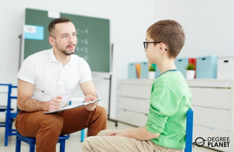 School Counselor in K12 School talking to a student