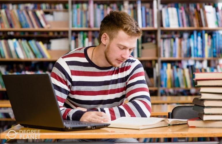 student studying in college library