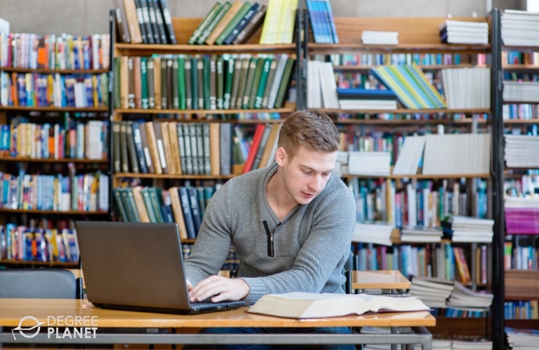 student studying in college library